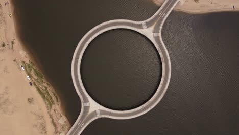 Aerial-top-down-view-over-unusual-circular-shape-bridge,-Laguna-Garzon