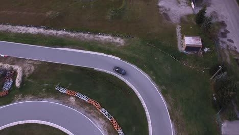 Aerial-shot-of-sport-car-racing-on-real-racetrack