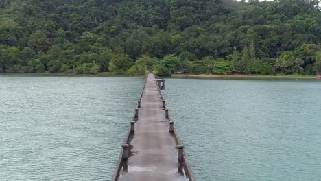 Slow-moving-shot-over-a-concrete-pier-after-rainfall-on-an-island-Cropped