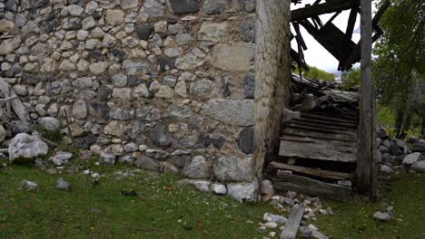 Ruined-stone-house-on-Alpine-Albanian-village-with-destroyed-roof-and-walls