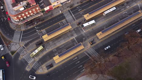 Aerial-top-down-of-public-bus-station-in-Chacarita-District-of-Buenos-Aires---Cars-driving-on-road-on-junction