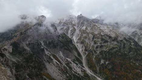 High-peak-of-mountain-covered-in-misty-fog-on-a-cloudy-Autumn-day-in-Albanian-Alps