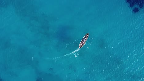 Birds-eye-view-drone-shot-of-a-team-of-rowers-on-a-rowing-boat-on-water
