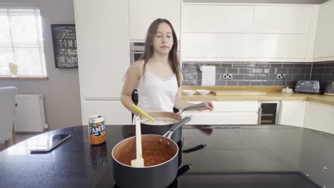young-girl-making-pasta-and-sauce-in-a-large-english-house-in-the-countryside,-lady-stressing-about-her-meal-because-she-is-a-perfectionist-and-doesn't-want-to-ruin-it