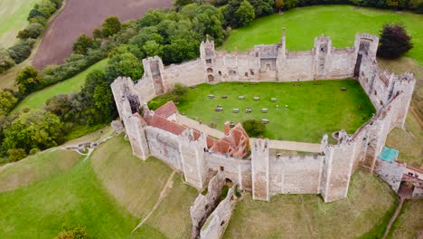 Aerial:-Framlingham-Castle-with-green-land-at-Suffolk,-England---drone-tracking-top-shot