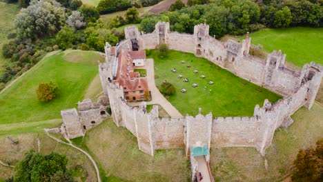 Aerial:-Framlingham-Castle-with-nature-surrounding-at-Suffolk,-England---drone-tracking-top-shot