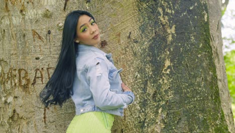 Latina-girl-wearing-a-jacket-turns-and-reveals-her-short-green-dress