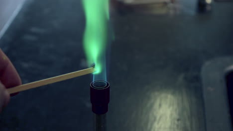 Close-up-of-blue-bunsen-burner-flame-followed-by-copper-flame-test-burning-green