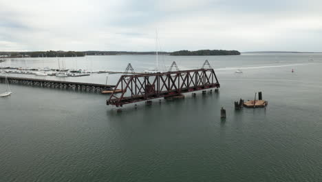 Gorgeous-aerial-wide-shot-of-the-old-train-bridge-in-Casco-Bay,-Maine
