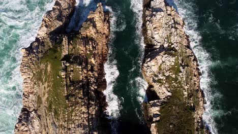 Waves-crash-around-two-rocky-cliffs-that-reach-into-the-Atlantic-Ocean