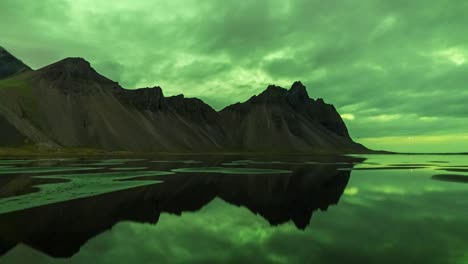 Bright-green-colors-of-the-Aurora-Borealis-over-the-Vestrahorn-mountains,-Iceland