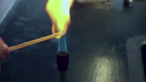 Close-up-of-blue-bunsen-burner-flame-followed-by-sodium-flame-test-burning-yellow