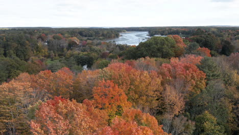 Beautiful-autumn-aerial-shot-panning-up-to-reveal-the-Royal-River-running-through-Yarmouth,-Maine