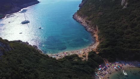 Aerial-shot-of-stunning-blue-lagoon-with-wild-beach-full-of-people