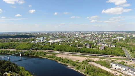 Flying-over-Panemune-with-majestic-view-of-Kaunas-cityscape-on-sunny-day,-aerial-drone-view
