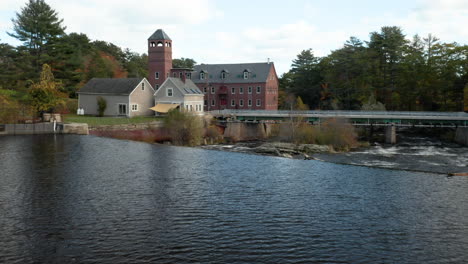 Stunning-aerial-push-in-on-the-Sparhawk-Grist-Mill-on-the-Royal-River-in-Yarmouth,-Maine