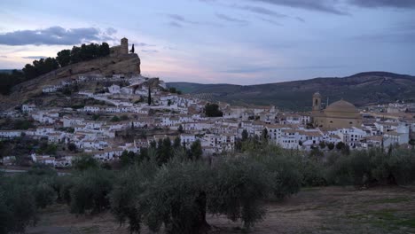 Beautiful-view-over-rural-Spanish-village-with-white-houses-and-church-on-hill-at-dusk