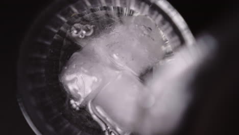 Ice-cube-cold-water-filling-closeup-glass