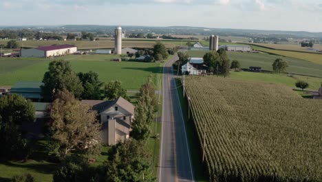 Aerial-reveal-above-road-through-rural-American-countryside