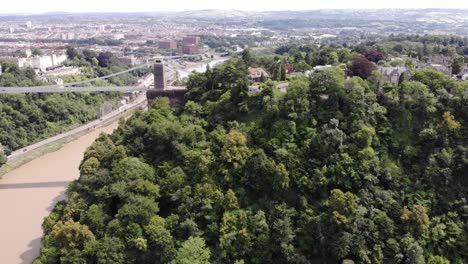 Aerial-Pan-Left-Above-Leigh-Woods-With-Reveal-Of-Clifton-Suspension-Bridge