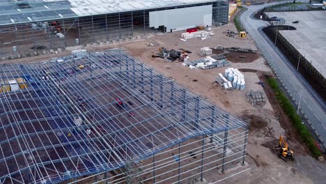 Incomplete-industrial-building-construction-site-structure-steel-framework-aerial-view