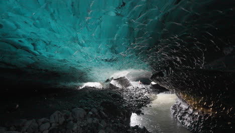 Pan-shot-of-natural-ice-cave-in-Breidamerkurjokull-Glacier-in-Iceland---4K-Footage