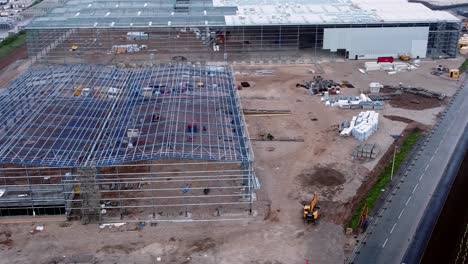Incomplete-industrial-building-construction-assembly-site-steel-framework-aerial-view