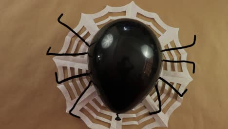 Halloween-decorations.-Black-spider-balloon-and-paper-spiderweb