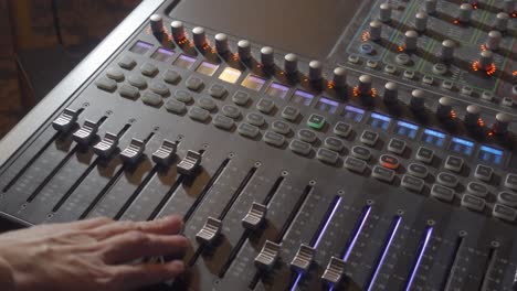A-Person-Changing-Controls-and-Moving-Knobs-on-a-Music-Mixer