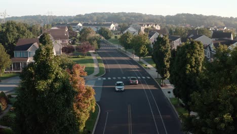 Aerial-of-traffic-driving-through-residential-suburban-community-in-USA