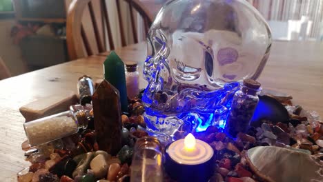 Collection-of-colourful-shaman-healing-crystals-and-mysterious-spiritual-skull-on-wooden-kitchen-table