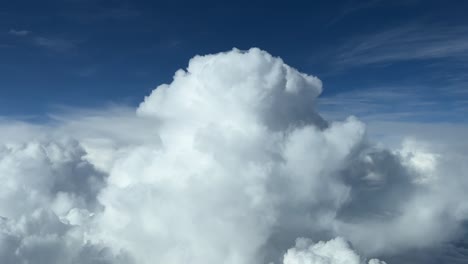 Aerial-view-taken-from-a-jet-cockpit-of-the-top-of-a-cumulonimbus-at-cruise-level,-daylight