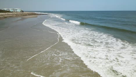 Waves-break-along-Kure-Beach-North-Carolina-shoreline-low-aerial