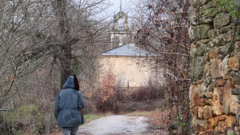 Young-man-walking-towards-a-rurtal-church