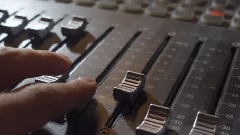 A-Person-Adjusting-the-Audio-Levels-on-a-Music-Mixer