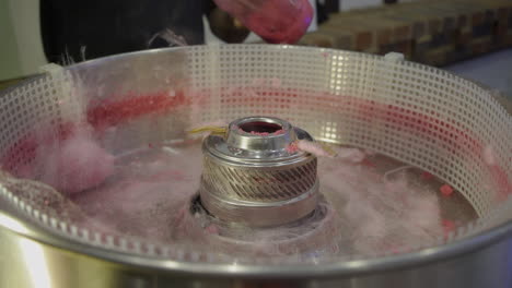 A-spinning-cotton-candy-sticking-on-the-stick-in-the-machine