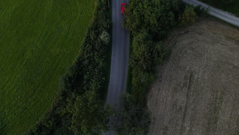 Aerial-view-of-passing-cars-on-a-forest-road-full-of-stories