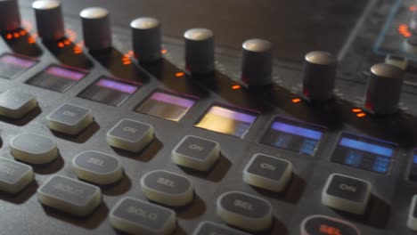 A-Close-Up-Panning-Shot-of-a-Music-Mixer-Board-with-Colorful-Buttons-and-Knobs