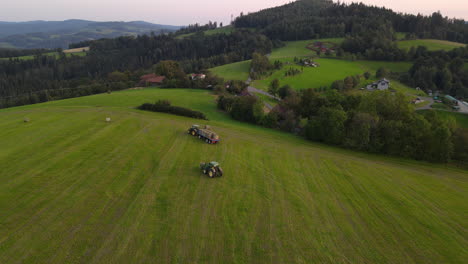 Aerial-view-of-agricultural-machinery-harvesting-crops-in-hilly-landscape