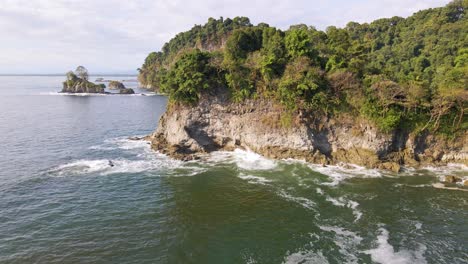 Waves-crashing-against-the-lush,-untouched-coastline-of-west-Costa-Rica