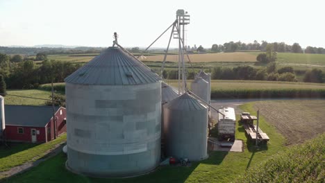 Grain-bin-elevator-storage-with-truck-in-rural-countryside-farm