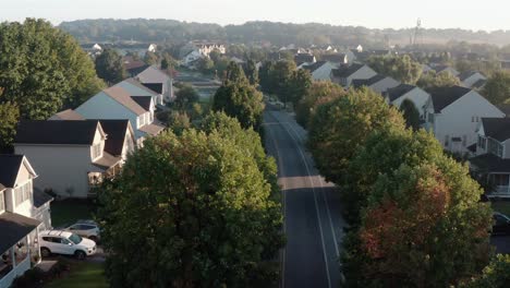 Aerial-of-cars-on-street-through-American-suburb