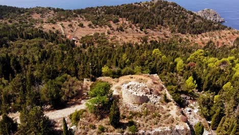 Remains-of-Venetian-watchtower-Assos-Castle,-Asos,-Kefalonia,-Ionian-Islands,-Greece---aerial-drone-shot