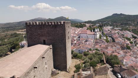 Aerial-pullback-from-romantic-village-revealing-Old-Castle,-Castelo-de-Vide---Portugal
