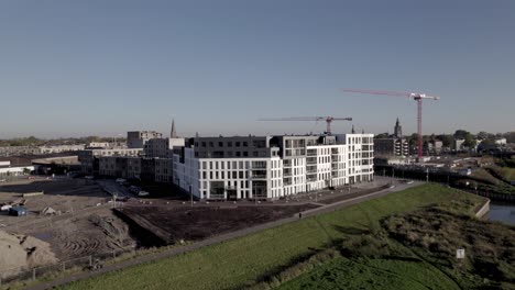 Kade-Noord-Apartmentkomplex-Am-Ufer-Des-Flusses-Ijssel-Mit-Aufschlussreicher-Baustelle-Von-Kade-Zuid-Mit-Großen-Roten-Kränen-Im-Viertel-Noorderhaven-Der-Turmstadt-Zutphen