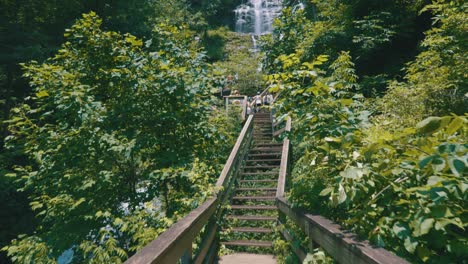 Epic-footage-of-a-footbridge-leading-up-to-Amicalola-Falls,-the-largest-waterfall-in-all-of-Georgia-–-towering-over-the-area-at-729-feet-tall