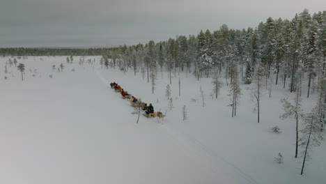 A-Group-Of-People-In-Sleds-Pulled-By-Reindeers-In-Muonio-Finland---aerial-shot