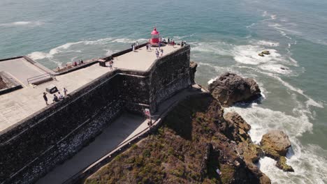 Touristen-Am-Roten-Leuchtturm-Von-Nazare-In-Der-Festung-Des-Erzengels-Michael-In-Portugal