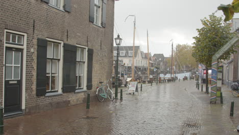 Tilt-down-over-small-street-in-typical-small-Dutch-fishing-village