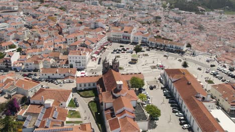 Aerial-panoramic-view-of-Nazaré-old-town-and-central-square-with-beach-in-background,-Portugal